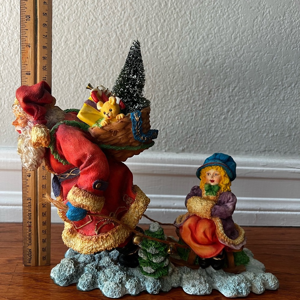 Dept 56 In The Spirit Santa Sculpture. Santa pulling little girl on a sled.